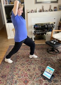 Photo of a woman using the Fitting Fitness In At Home programs to exercise at home