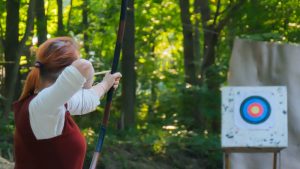 Women shooting arrow at a target.