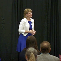 Holly Kouvo speaking at a conference about Rena\'s Story
