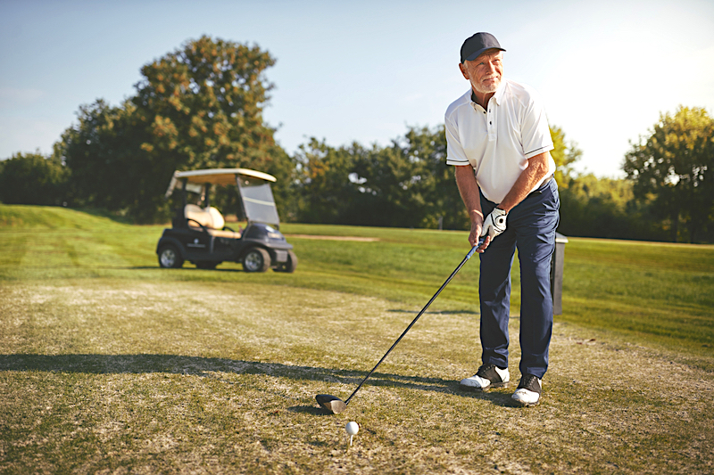 Man golfing in the Summer