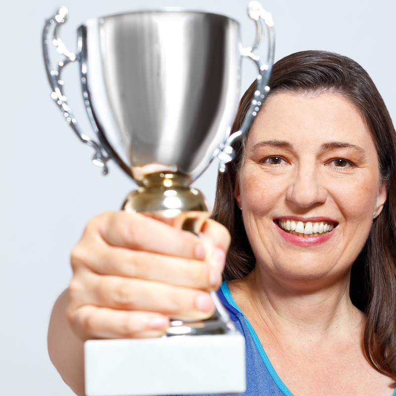 Image of woman holding up a trophy