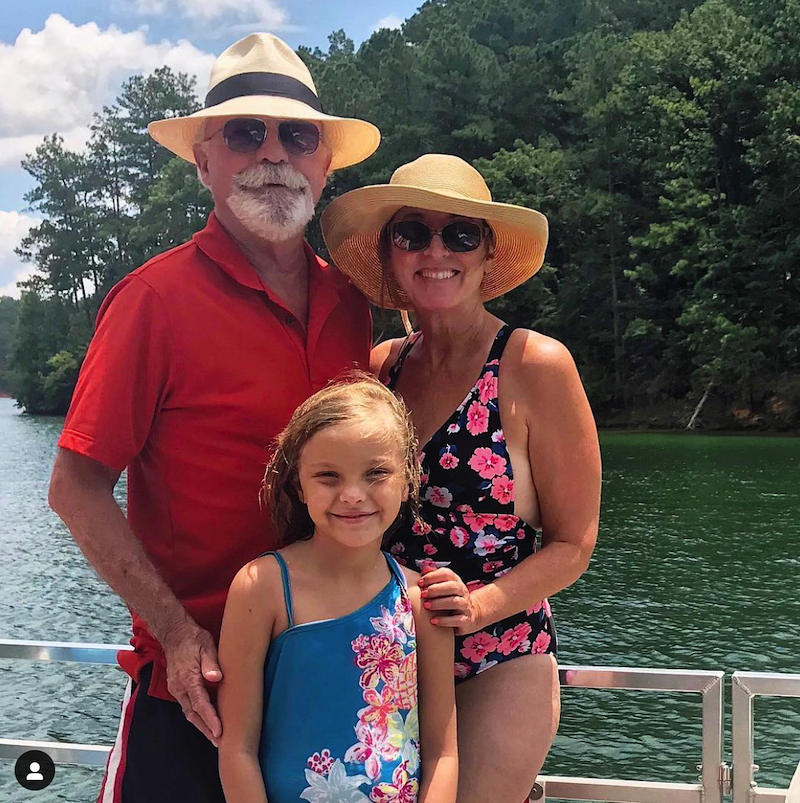 grandparents and grandchild by the water