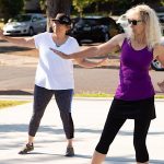 two women doing a fitness dance routine