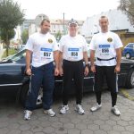 Vince Obsitnik stands with 2 other marathoners, all wearing numbers