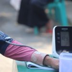 close up of an arm wearing a blood pressure cuff