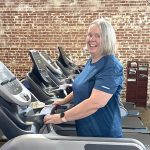 Mary Frances smiles at the camera while on a treadmill