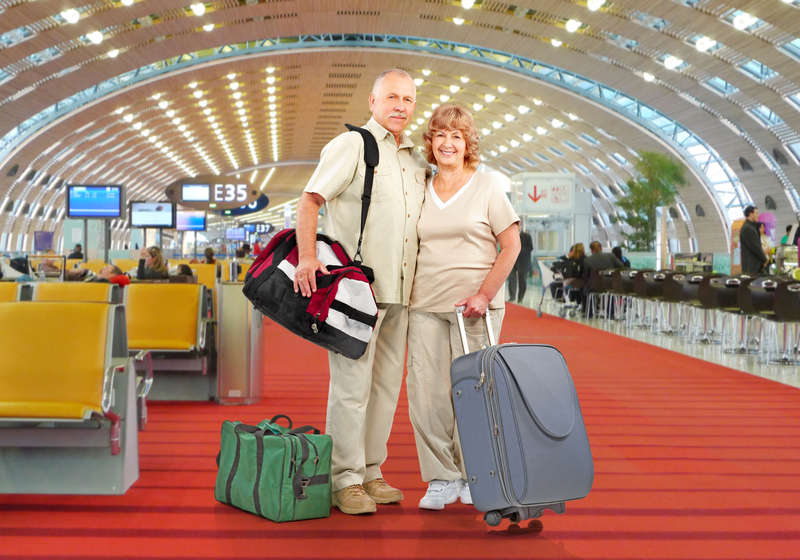Older couple with luggage in an airport